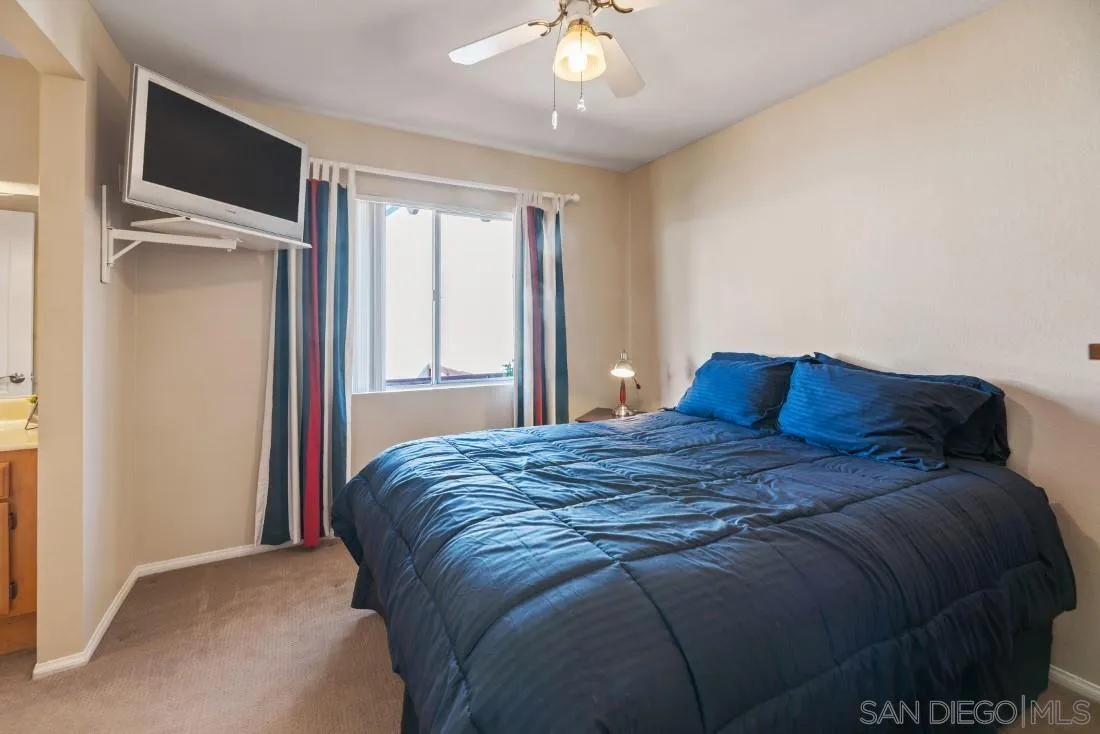 13755 Royal Melbourne Square San Diego, CA 92128 - Photo 53 of 75 a bed sitting in a bedroom next to a window