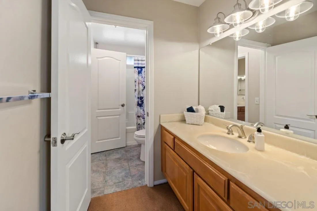 13755 Royal Melbourne Square San Diego, CA 92128 - Photo 56 of 75 a bathroom with a sink a toilet and shower