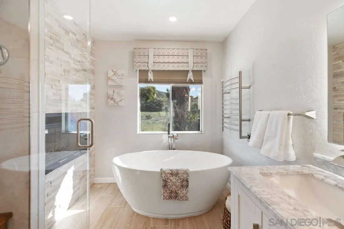 13755 Royal Melbourne Square San Diego, CA 92128 - Photo 62 of 75 a bathroom with a tub sink and mirror