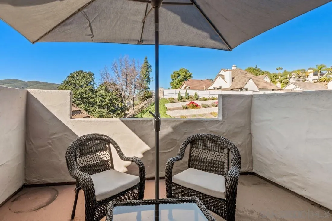 13755 Royal Melbourne Square San Diego, CA 92128 - Photo 63 of 75 a view of a balcony with chair and table