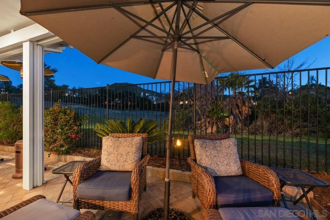 13755 Royal Melbourne Square San Diego, CA 92128 - Photo 69 of 75 a view of a patio with a table and chairs under an umbrella