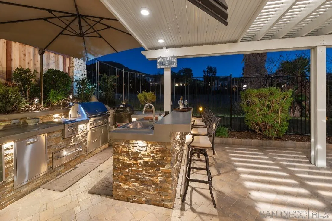 13755 Royal Melbourne Square San Diego, CA 92128 - Photo 71 of 75 a view of a patio with table and chairs under an umbrella