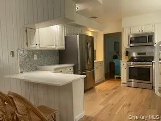 a kitchen with stainless steel appliances a stove a sink and a refrigerator