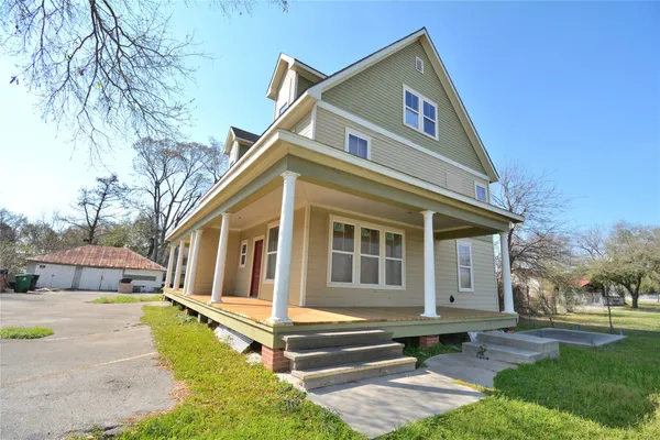 a view of a house with a yard and sitting area