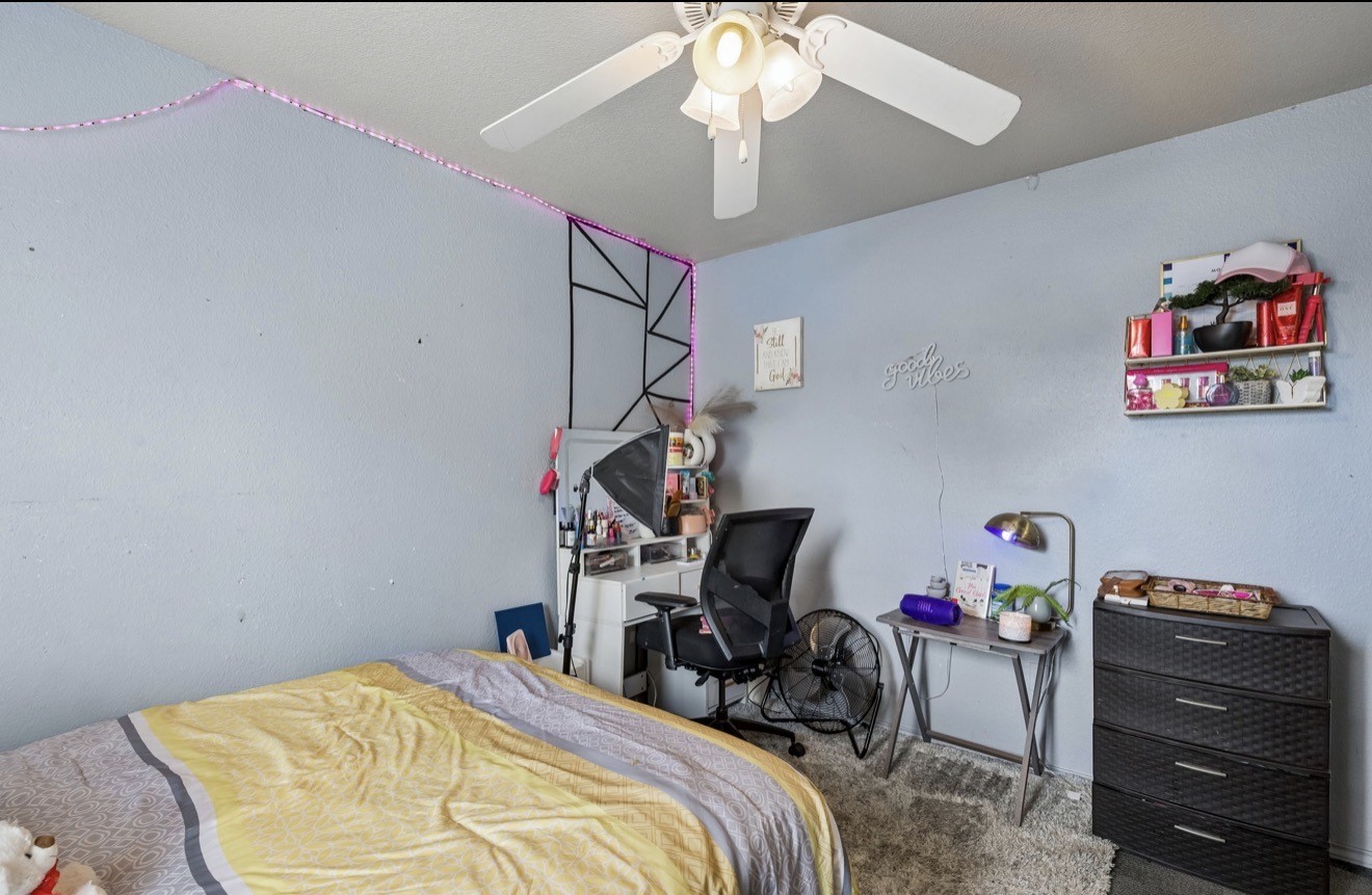 7118 Rising Brook Drive Cypress, TX 77433 - Photo 18 of 21 a bedroom with bed and a chandelier