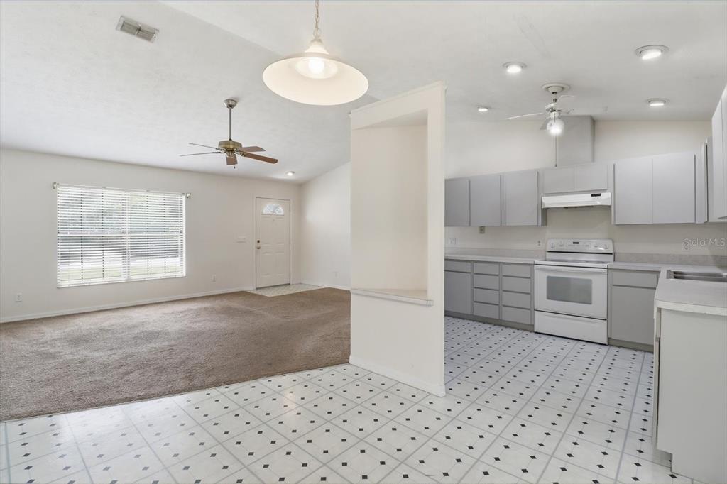 6355 East Rush Street Inverness, FL 34452 - Photo 7 of 27 a kitchen with a sink a stove a refrigerator and cabinets