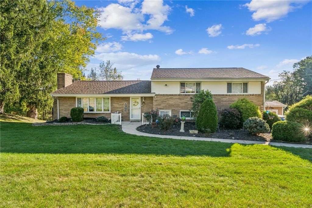 a front view of a house with a yard patio and fire pit