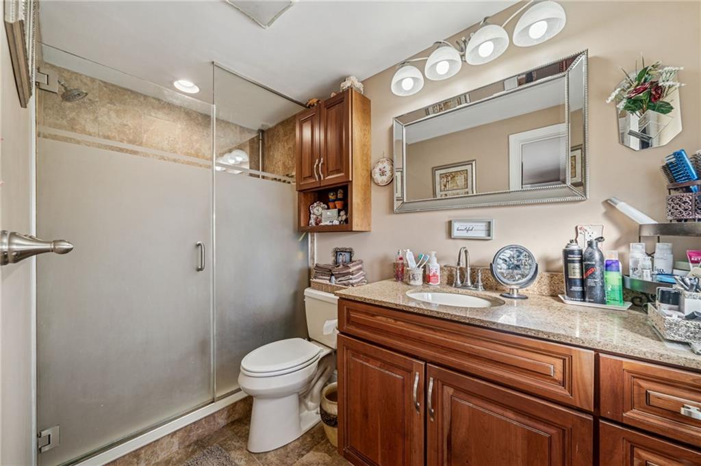 228 Ridgeview Drive Venetia, PA 15367 - Photo 17 of 37 a bathroom with a granite countertop toilet sink and mirror