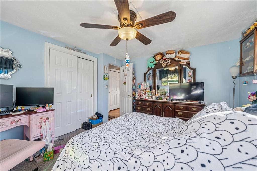 228 Ridgeview Drive Venetia, PA 15367 - Photo 18 of 37 a bedroom with a bed and a flat tv screen on dresser