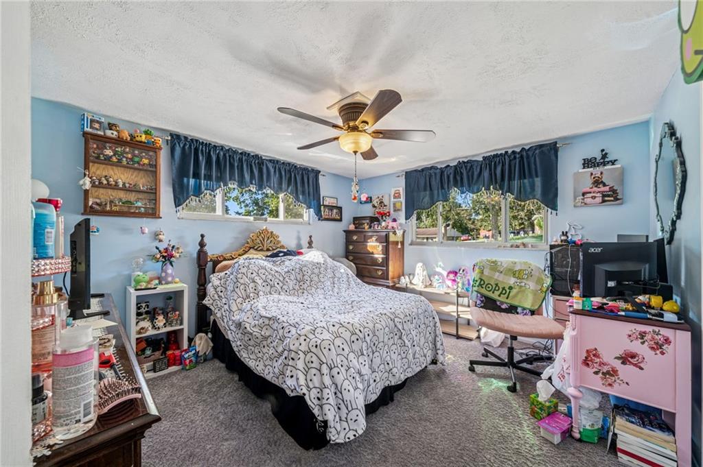 228 Ridgeview Drive Venetia, PA 15367 - Photo 19 of 37 a bed room with a bed a couch and a window