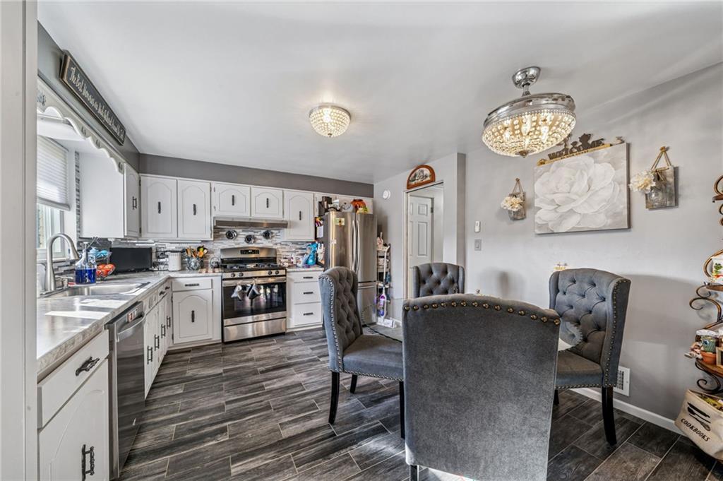 228 Ridgeview Drive Venetia, PA 15367 - Photo 6 of 37 a kitchen with stainless steel appliances granite countertop a stove refrigerator and a stove top oven