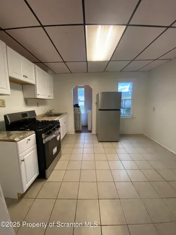 a kitchen with a sink a stove and a refrigerator