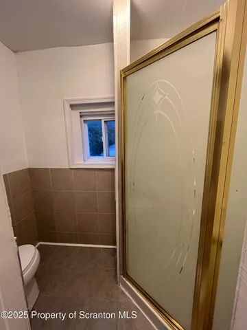 a bathroom with a glass shower door