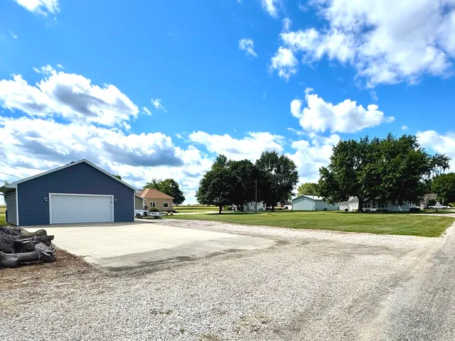 a view of a house with a yard and garage