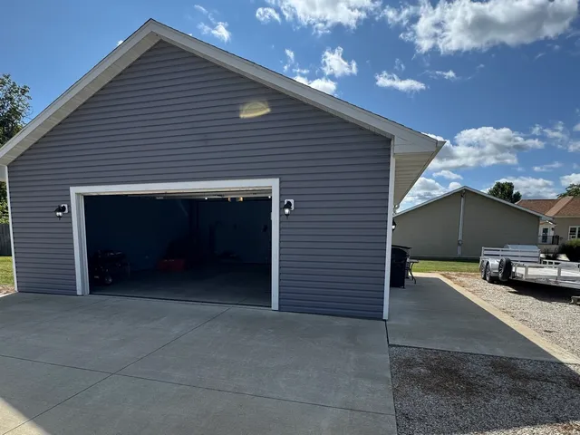 a view of a house with a yard and garage