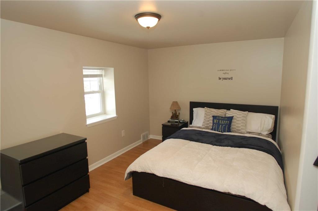 318 Rochester Road Freedom, PA 15042 - Photo 14 of 25 The second level guest bedroom is neutral and bright with a large closet.