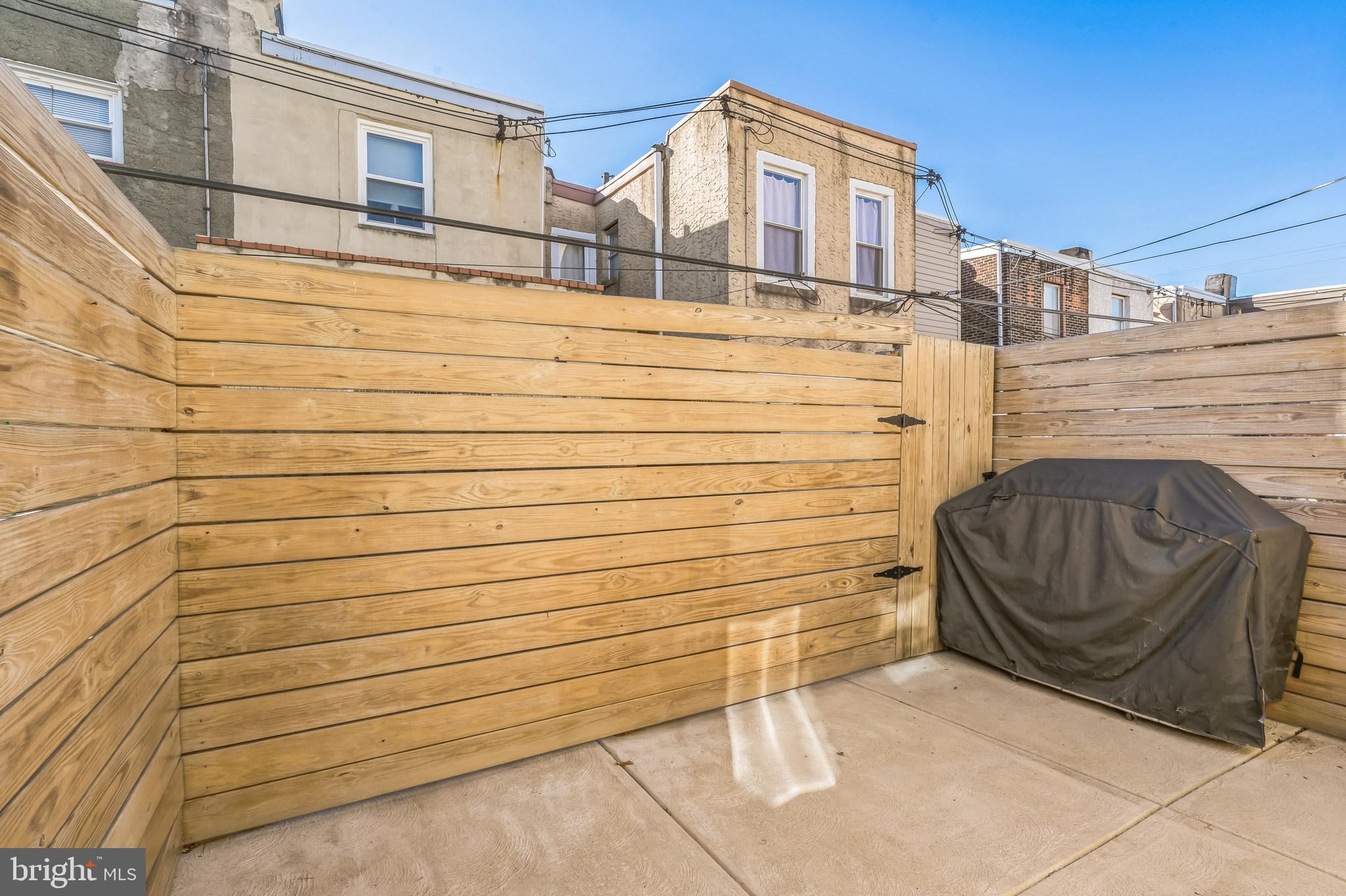 1838 Tree Street Philadelphia, PA 19145 - Photo 15 of 29 Back patio with wood privacy fence