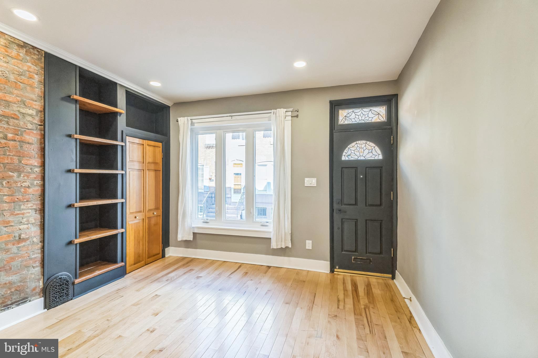 1838 Tree Street Philadelphia, PA 19145 - Photo 2 of 29 Living room with built-in shelving and coat closet