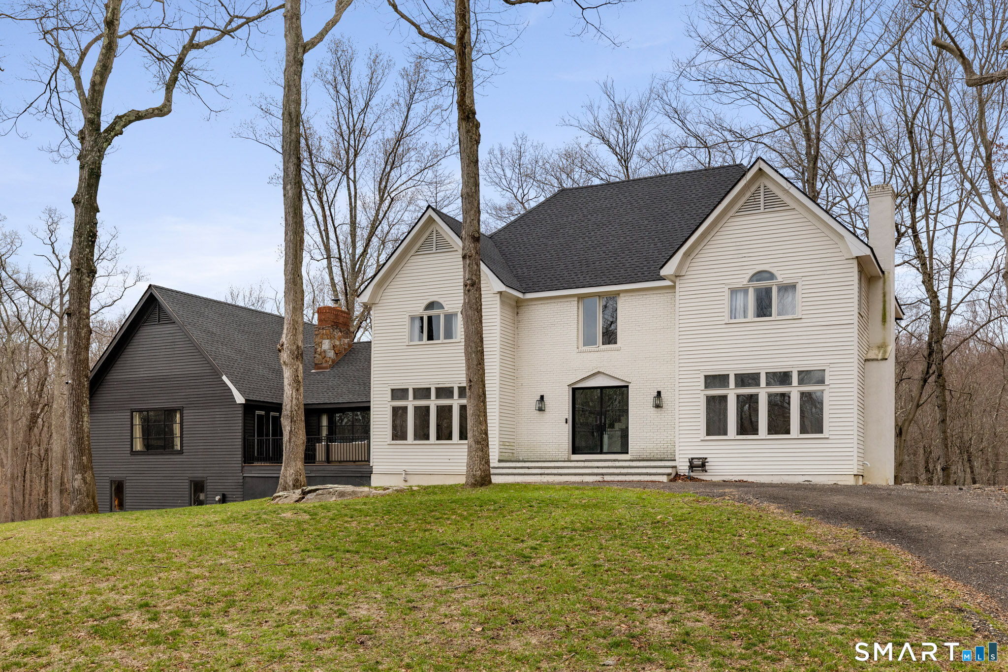 326 Thayer Pond Road Wilton, CT 06897 - Photo 1 of 40 a house that has a big yard and large trees