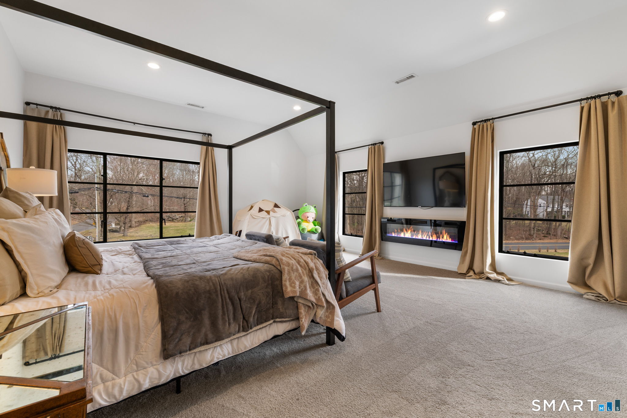 326 Thayer Pond Road Wilton, CT 06897 - Photo 12 of 40 a bed room with a bed and a television