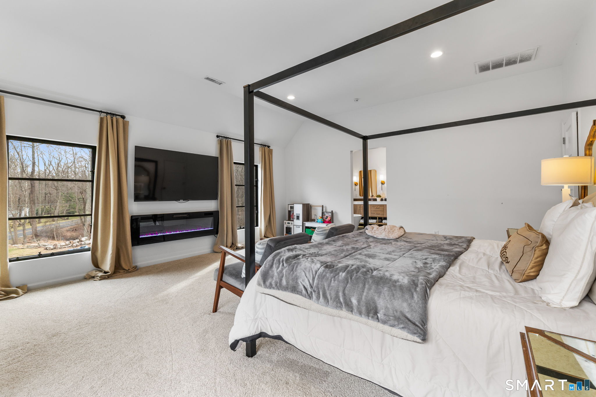 326 Thayer Pond Road Wilton, CT 06897 - Photo 15 of 40 a bedroom with a bed and large window