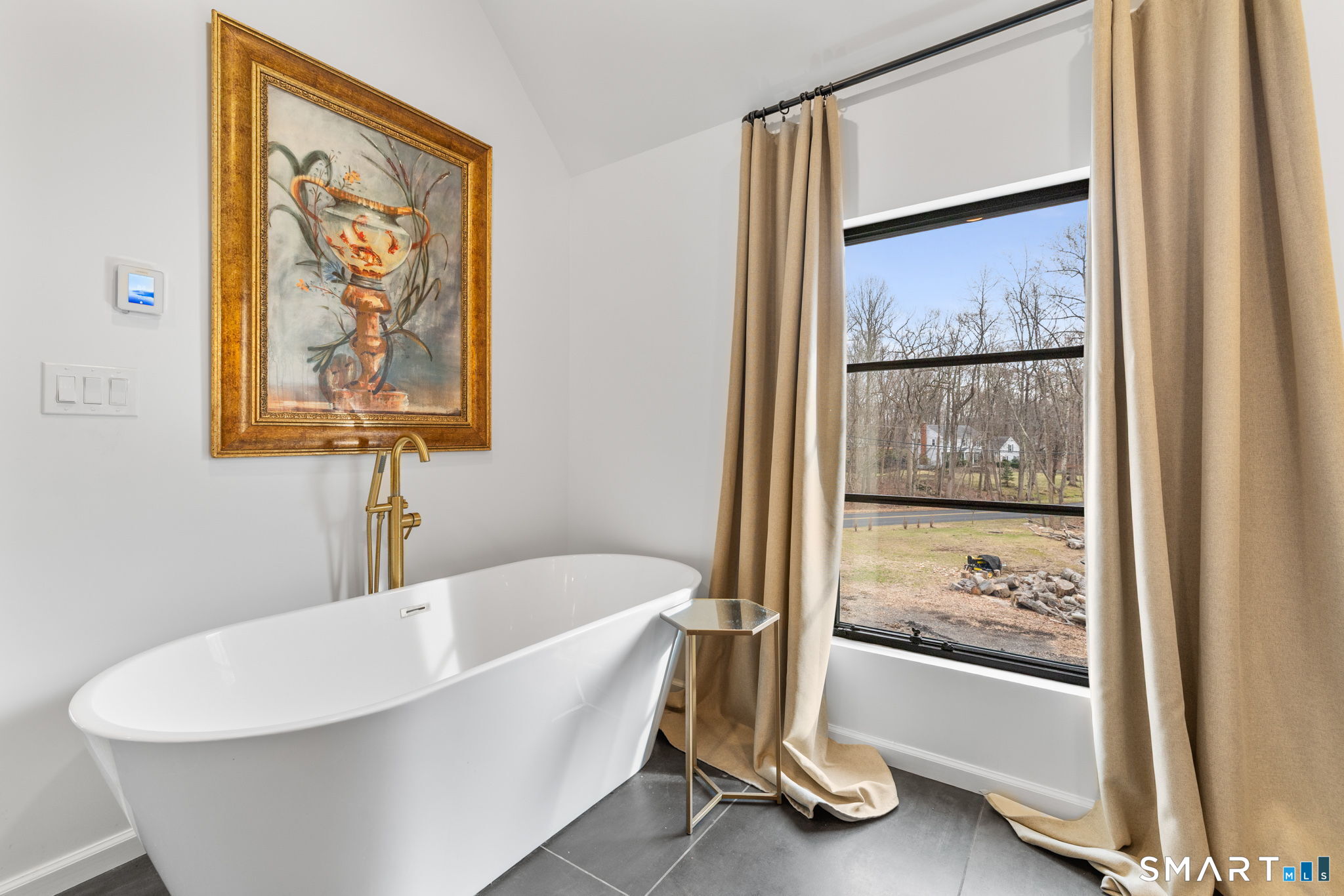 326 Thayer Pond Road Wilton, CT 06897 - Photo 18 of 40 a white bath tub sitting next to a window