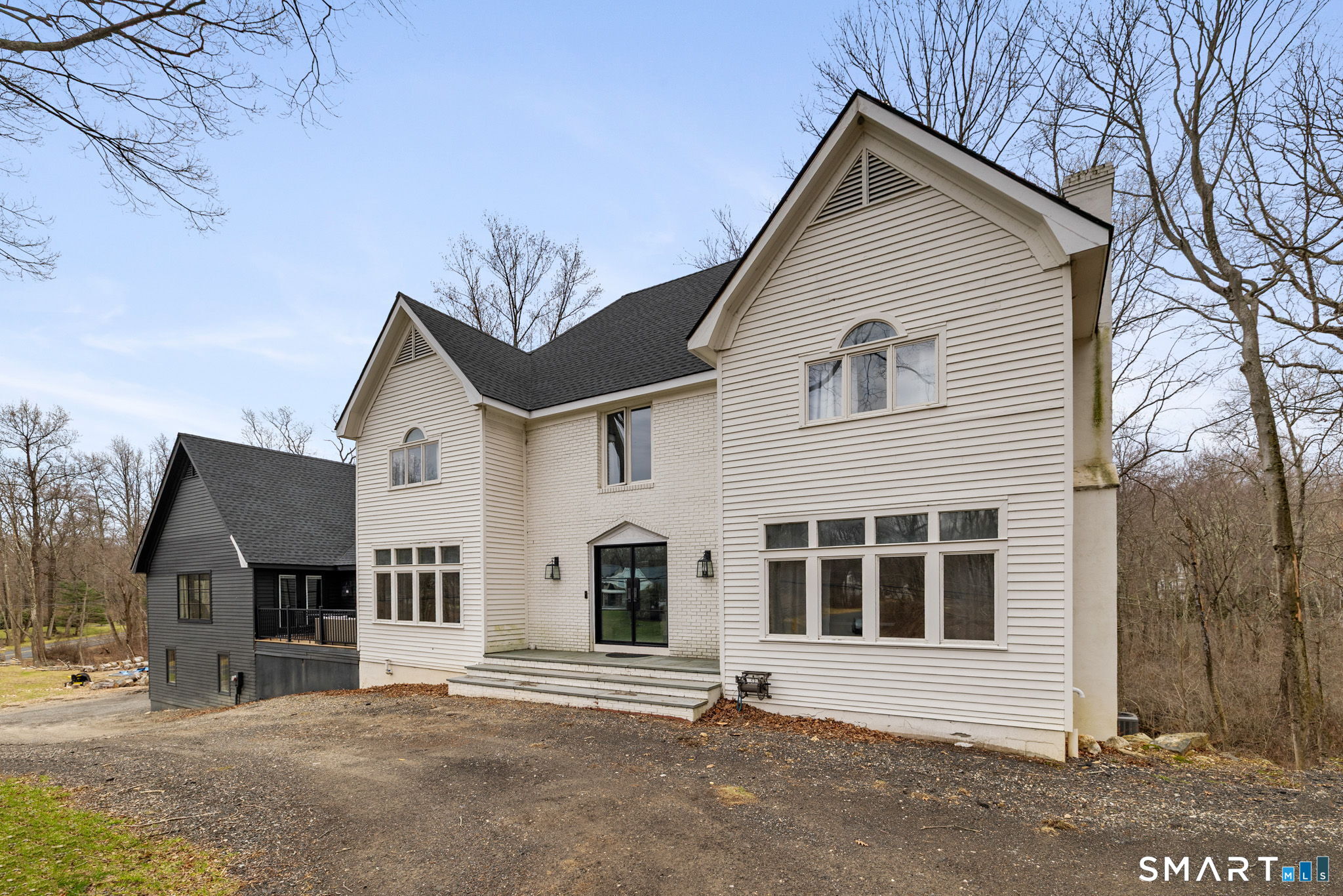 326 Thayer Pond Road Wilton, CT 06897 - Photo 2 of 40 a front view of a house with a yard