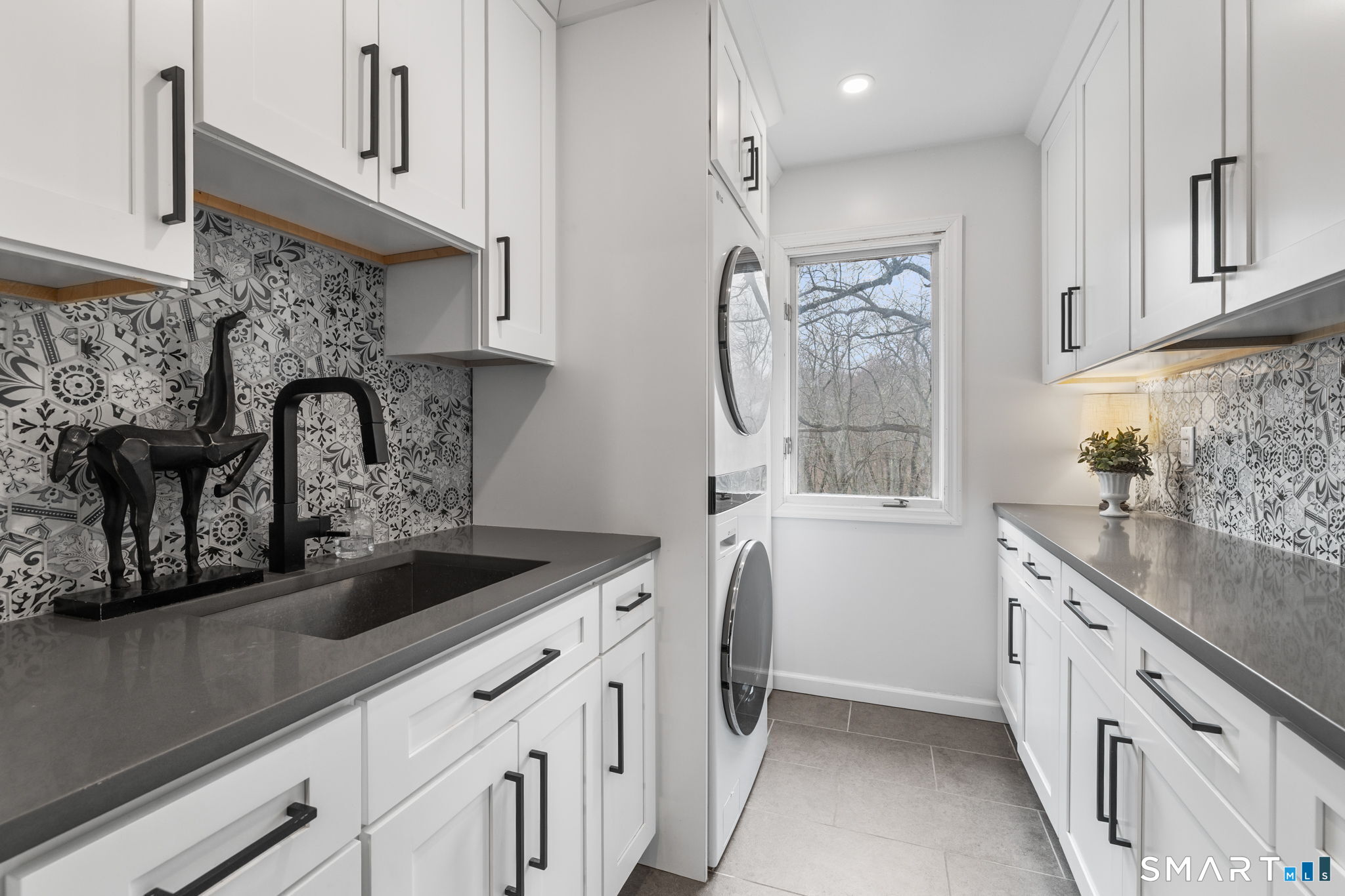 326 Thayer Pond Road Wilton, CT 06897 - Photo 22 of 40 a kitchen with granite countertop a sink a stove and cabinets