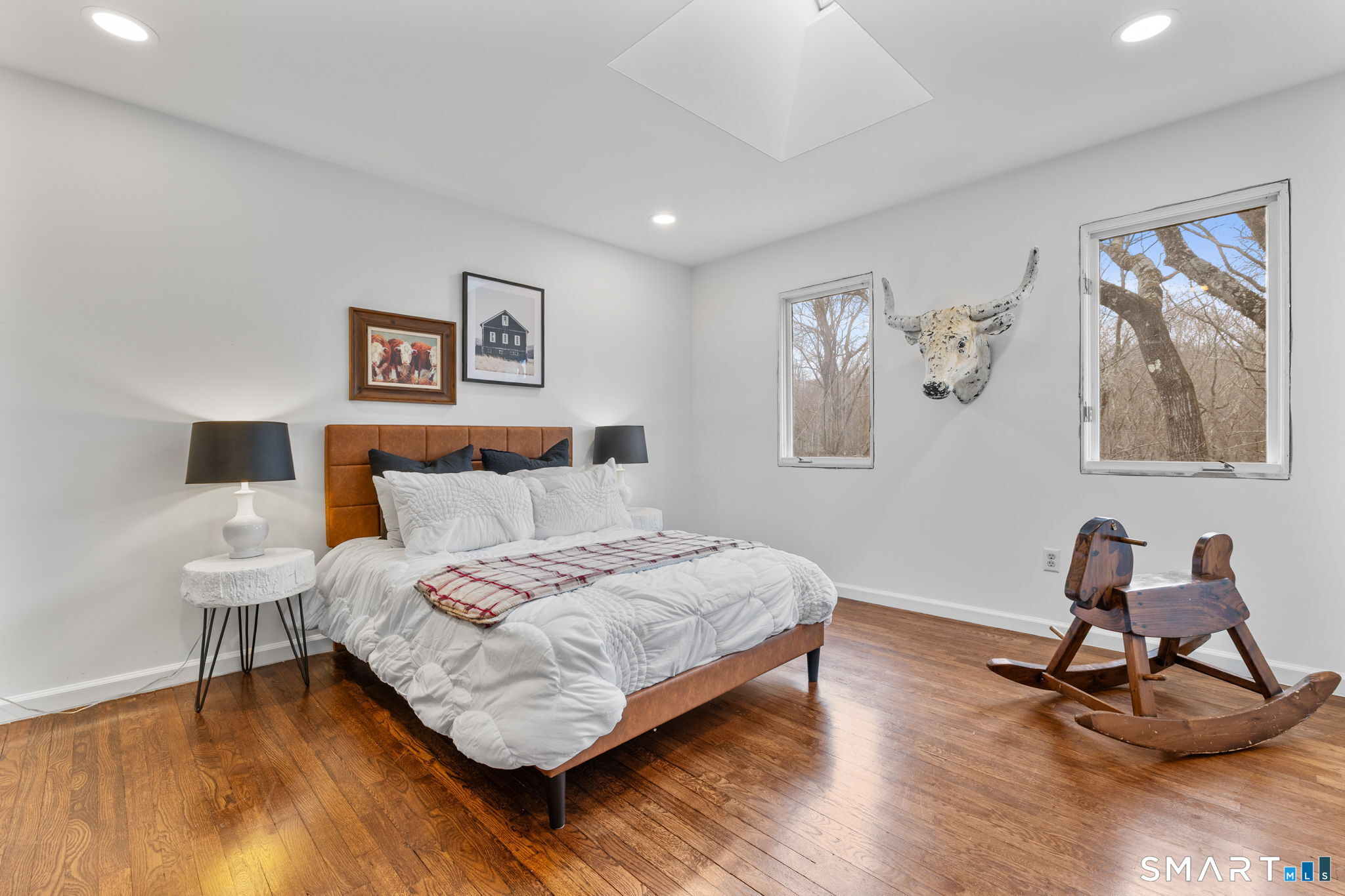 326 Thayer Pond Road Wilton, CT 06897 - Photo 23 of 40 a bedroom with a bed and a desk