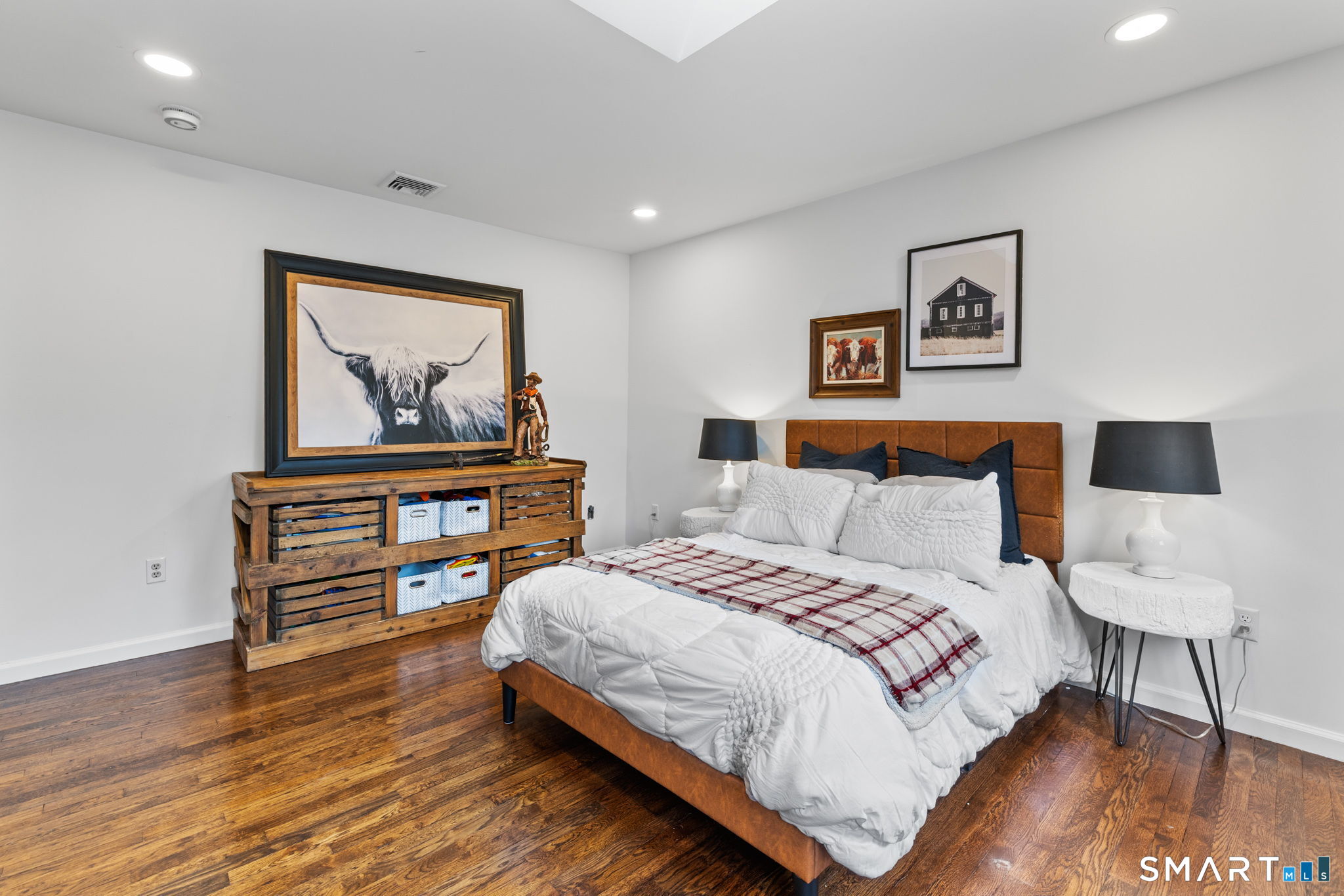 326 Thayer Pond Road Wilton, CT 06897 - Photo 24 of 40 a bedroom with a bed and a painting on the wall