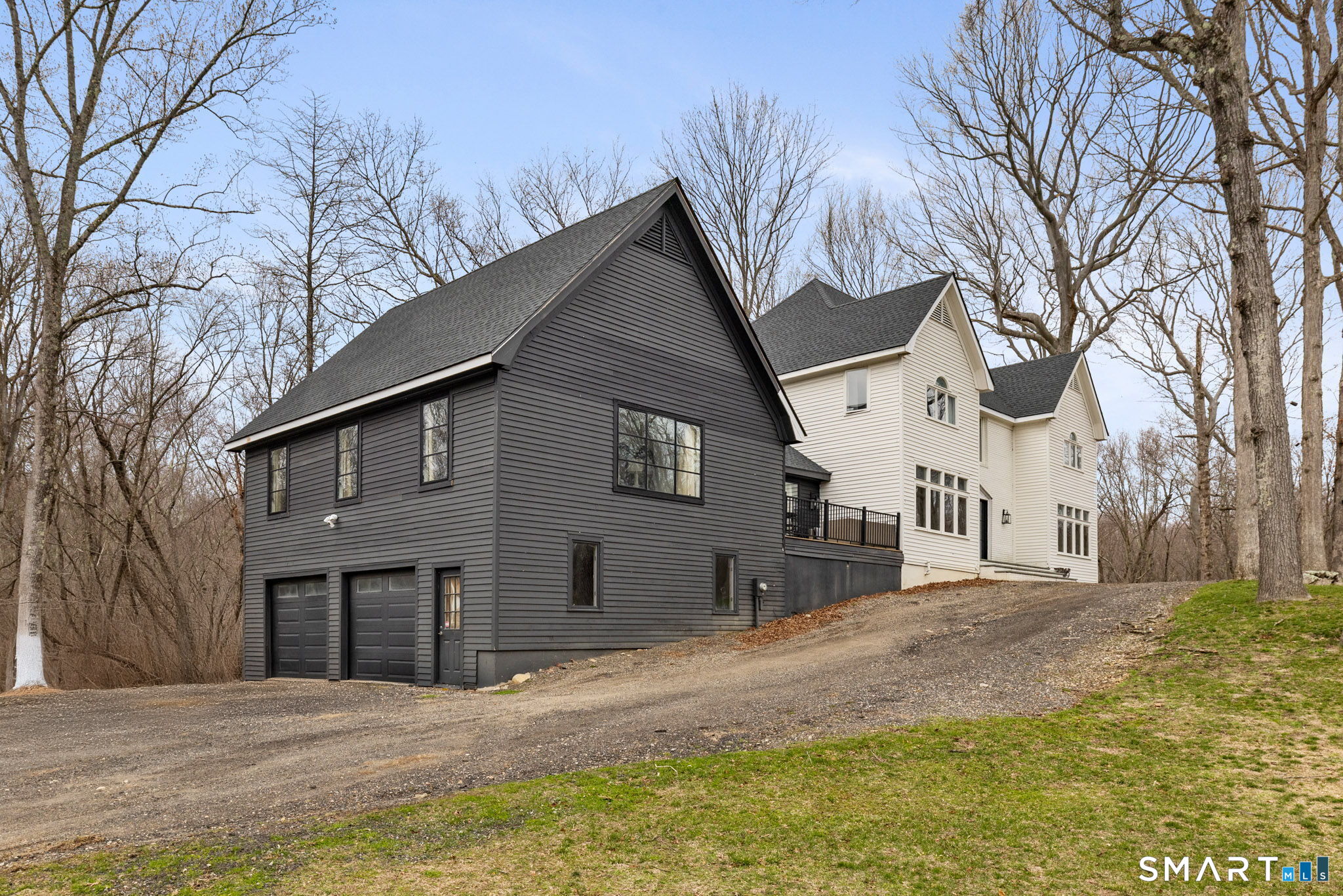326 Thayer Pond Road Wilton, CT 06897 - Photo 3 of 40 a front view of a house with a yard