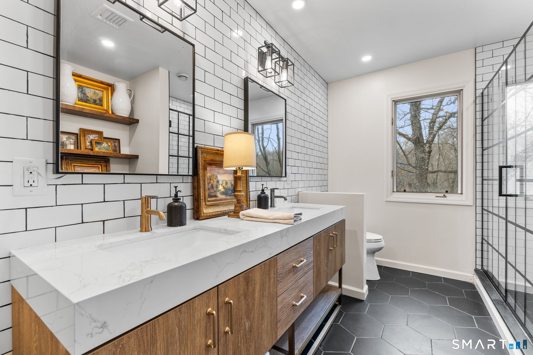 326 Thayer Pond Road Wilton, CT 06897 - Photo 32 of 40 a bathroom with a sink double vanity and a mirror
