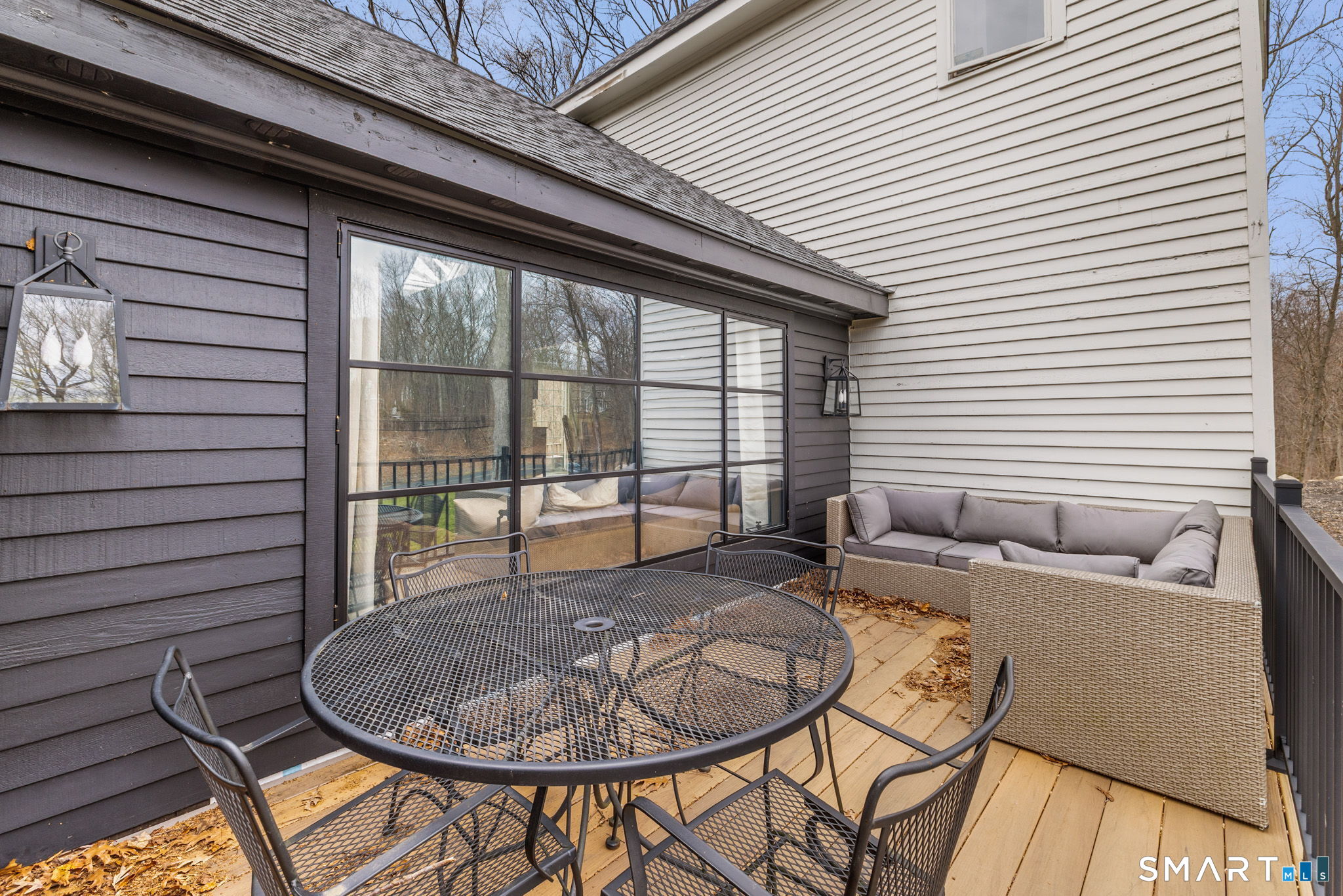 326 Thayer Pond Road Wilton, CT 06897 - Photo 39 of 40 a dinning table and chairs in a patio