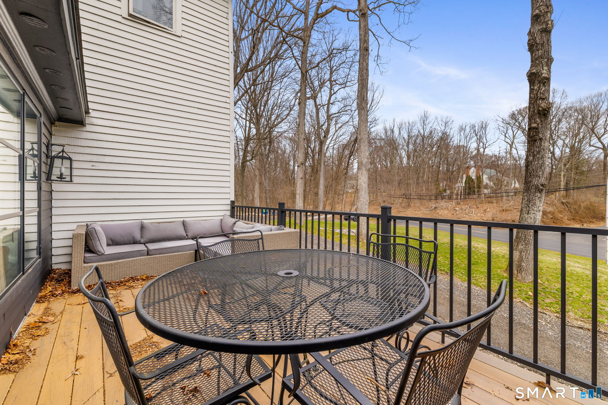 326 Thayer Pond Road Wilton, CT 06897 - Photo 40 of 40 a view of a balcony with furniture and wooden floor