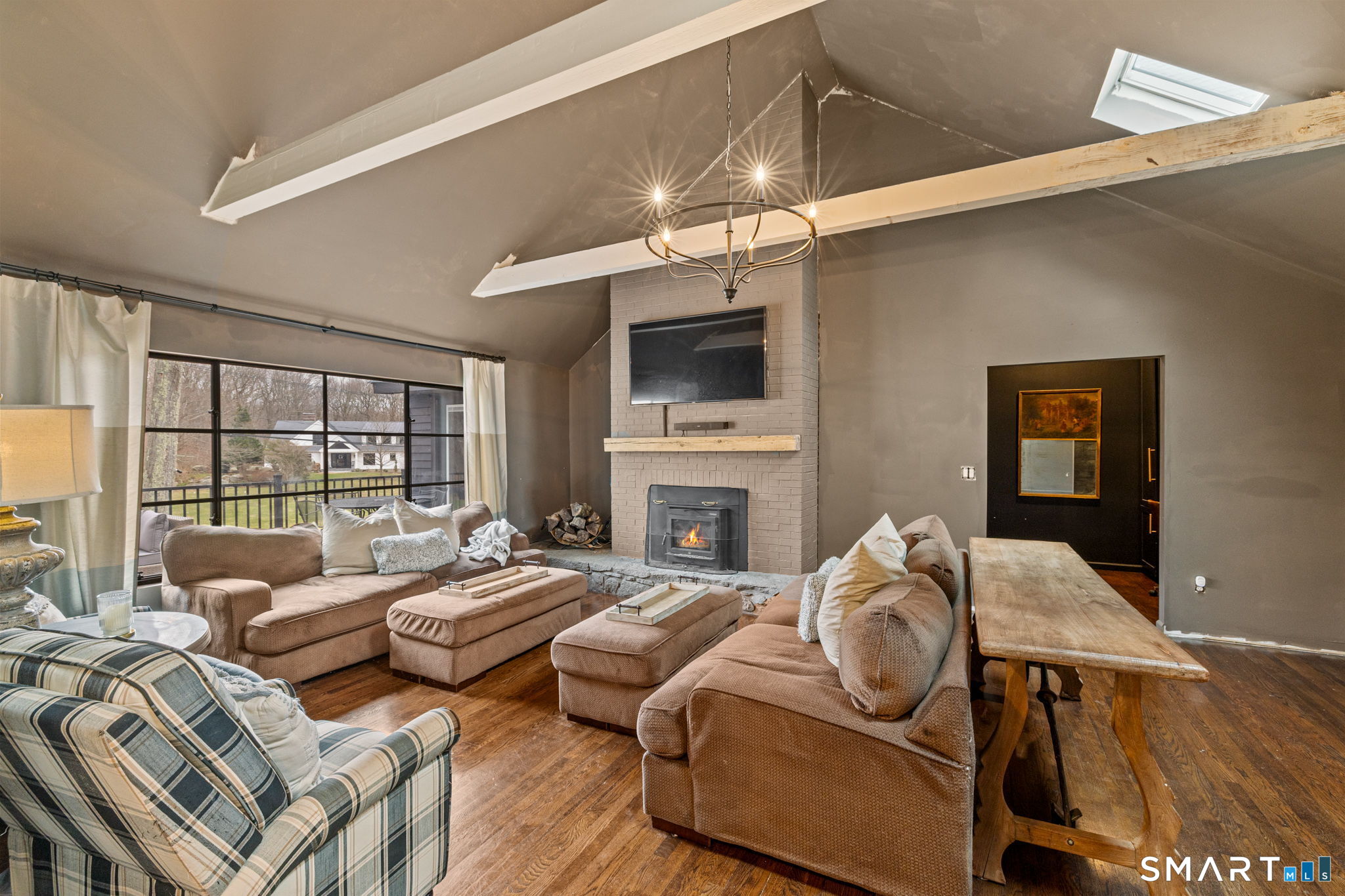 326 Thayer Pond Road Wilton, CT 06897 - Photo 4 of 40 a living room with fireplace furniture and a flat screen tv