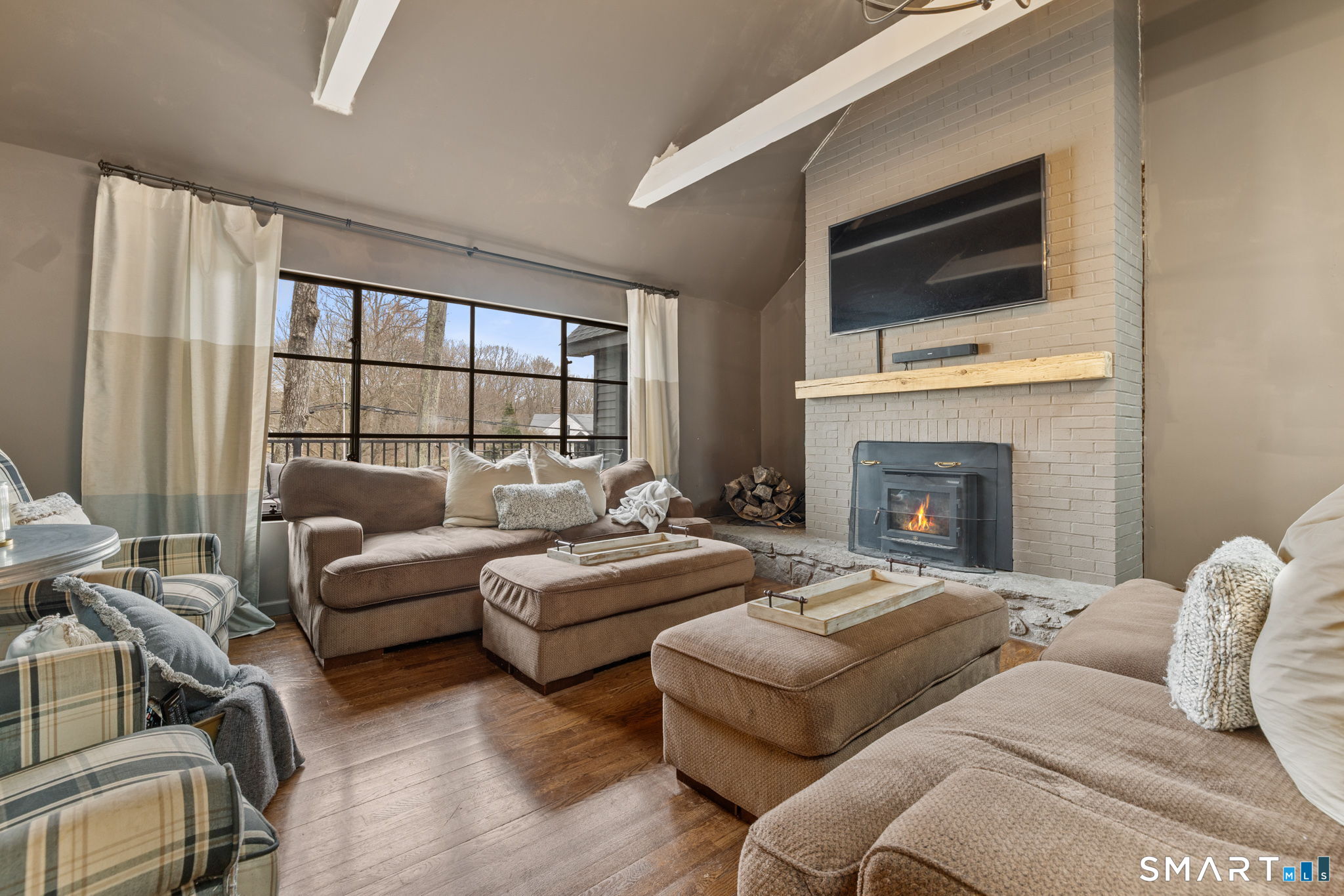 326 Thayer Pond Road Wilton, CT 06897 - Photo 6 of 40 a living room with furniture fireplace and flat screen tv