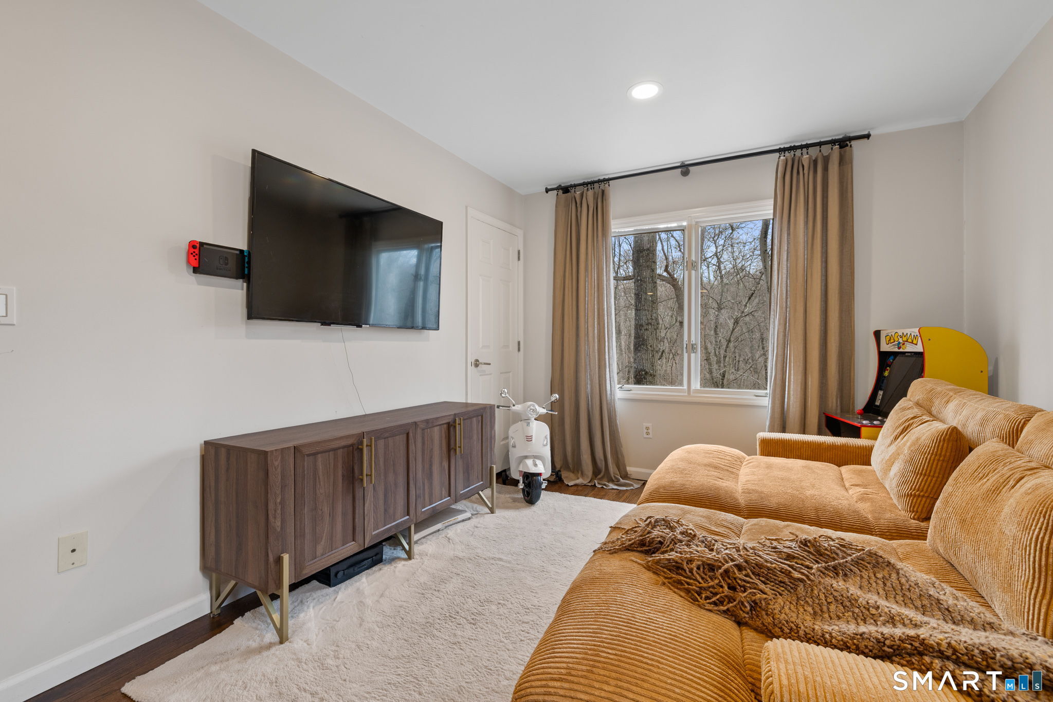 326 Thayer Pond Road Wilton, CT 06897 - Photo 7 of 40 a bedroom with a bed and flat screen tv