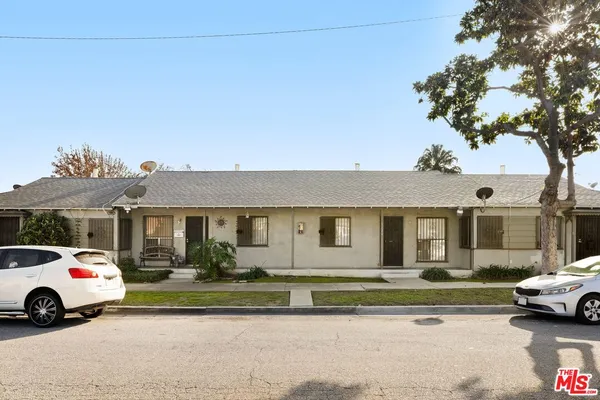a front view of a house with a yard table and chairs
