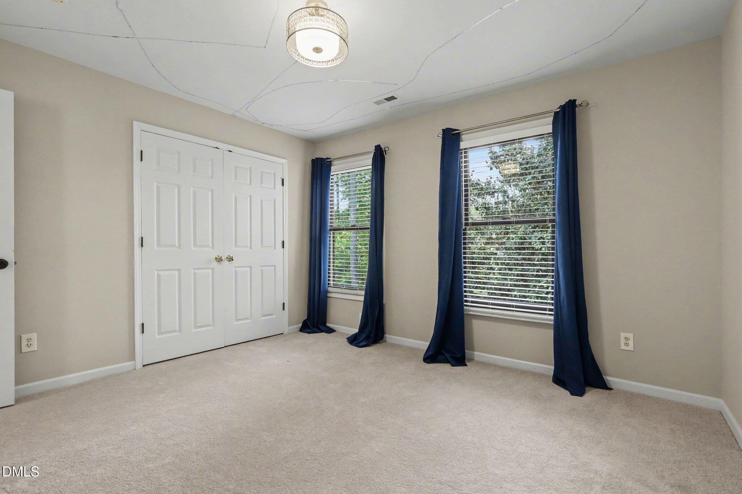1001 Denfield Court Raleigh, NC 27615 - Photo 21 of 44 an empty room with windows