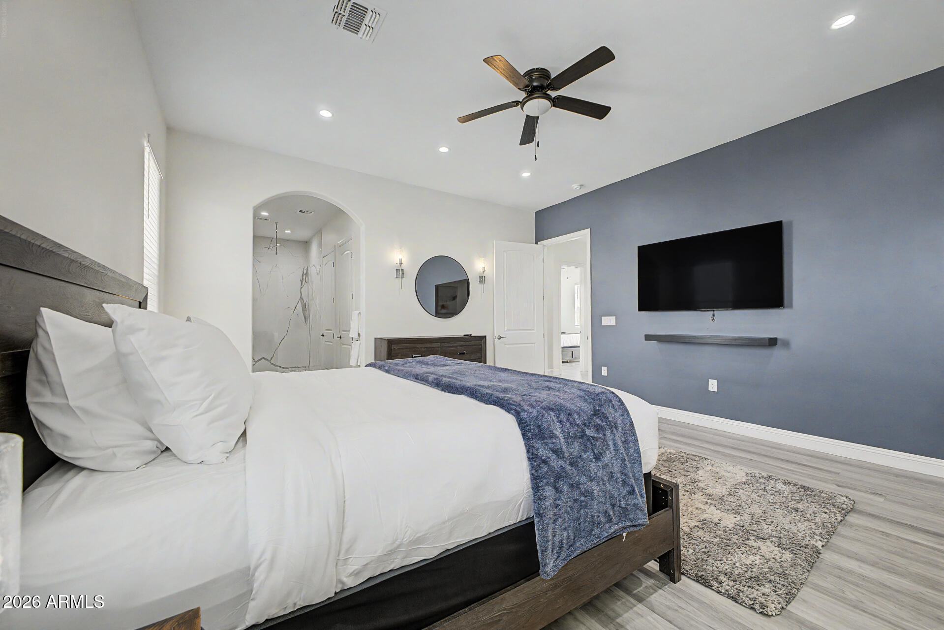 1344 East Polk Street, Unit B Phoenix, AZ 85006 - Photo 12 of 27 a bedroom with a bed and a flat screen tv