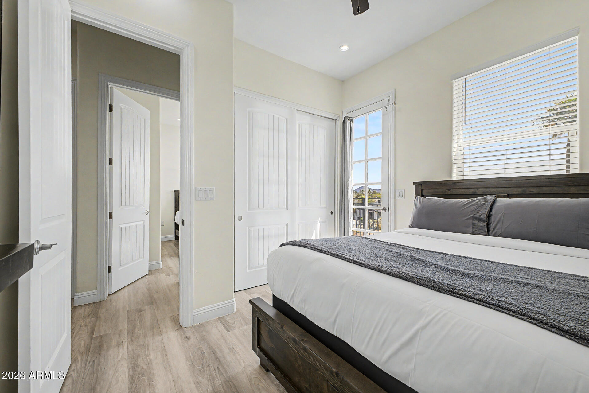 1344 East Polk Street, Unit B Phoenix, AZ 85006 - Photo 16 of 27 a spacious bedroom with a bed and wooden floor