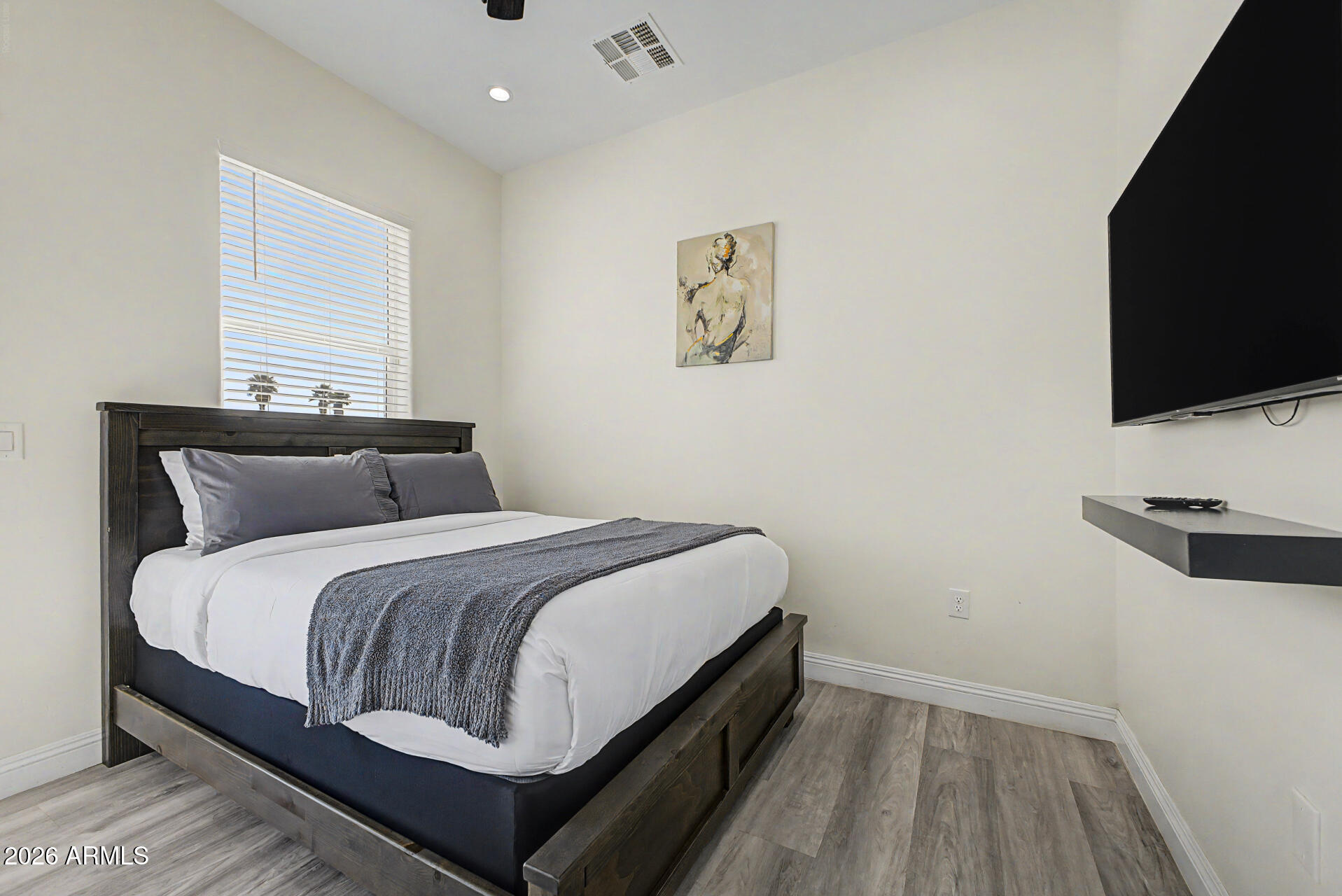 1344 East Polk Street, Unit B Phoenix, AZ 85006 - Photo 17 of 27 a bedroom with a bed and a flat screen tv