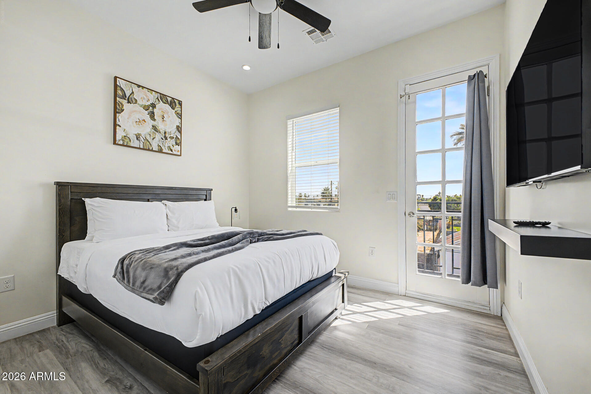 1344 East Polk Street, Unit B Phoenix, AZ 85006 - Photo 19 of 27 a bed room with a bed and a large window