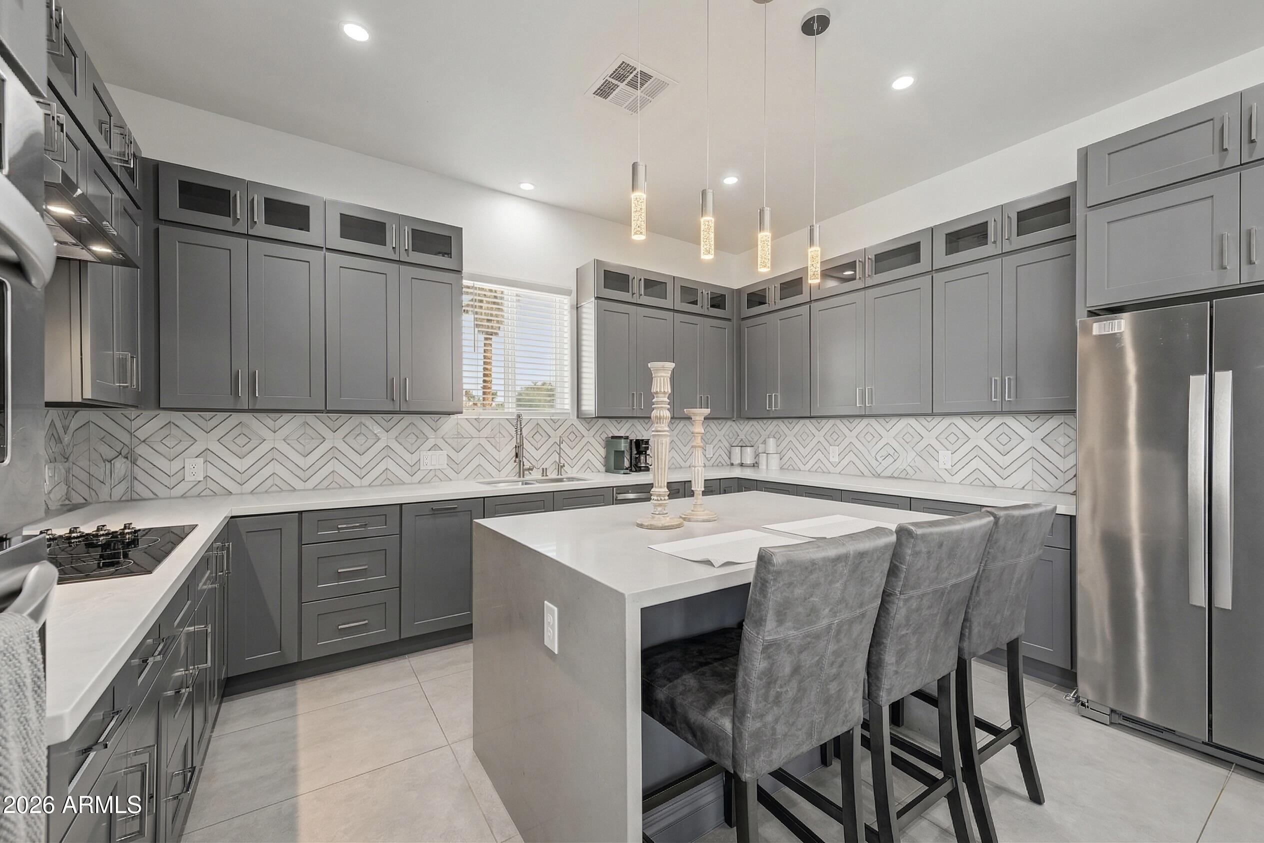 1344 East Polk Street, Unit B Phoenix, AZ 85006 - Photo 2 of 27 a kitchen with a sink a counter top space stainless steel appliances and cabinets