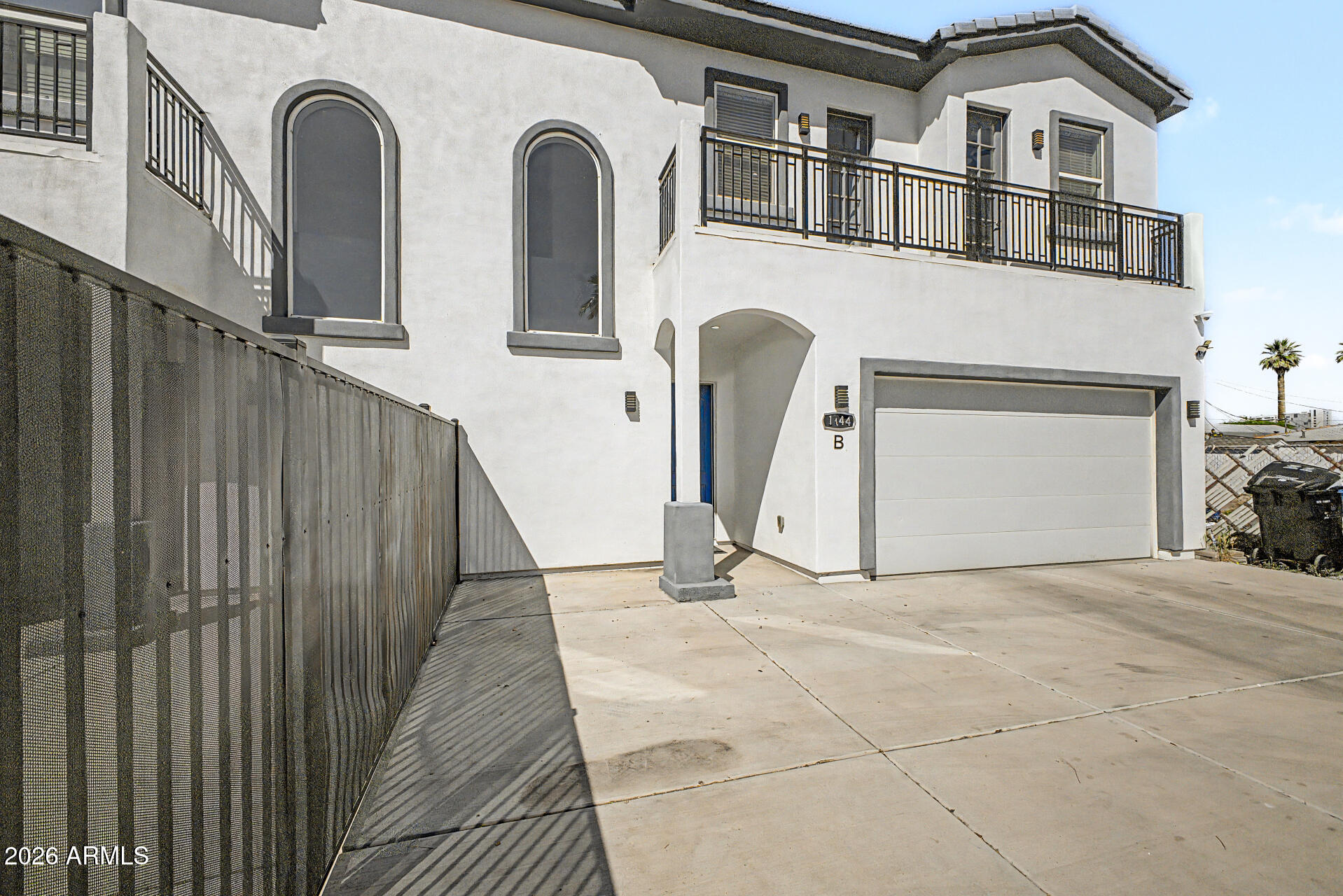 1344 East Polk Street, Unit B Phoenix, AZ 85006 - Photo 27 of 27 a view of a grey house with large door
