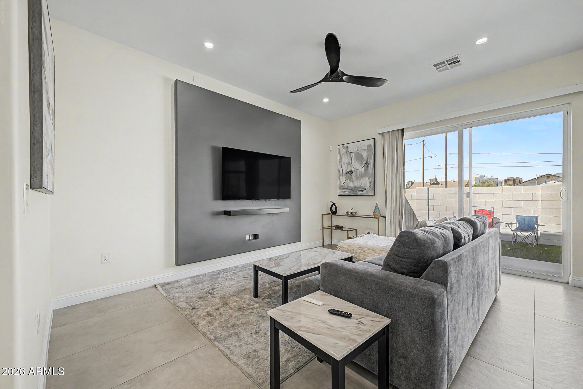 1344 East Polk Street, Unit B Phoenix, AZ 85006 - Photo 5 of 27 a living room with furniture and a flat screen tv