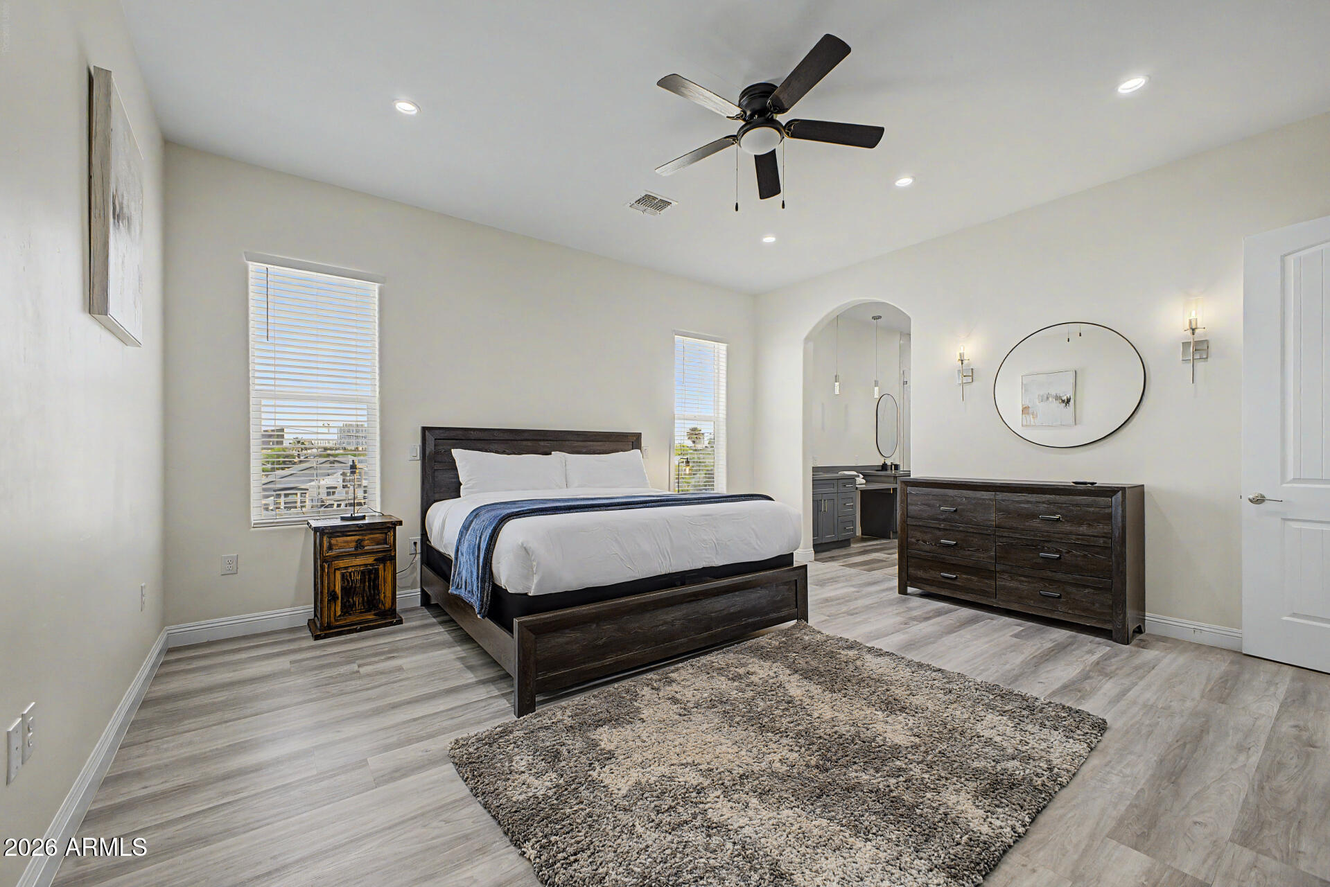 1344 East Polk Street, Unit B Phoenix, AZ 85006 - Photo 10 of 27 a bedroom with a bed a dresser and a large mirror