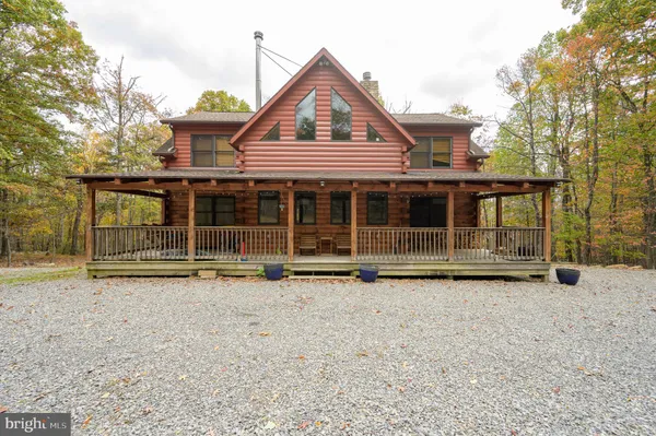 a view of a house with a yard and wooden fence