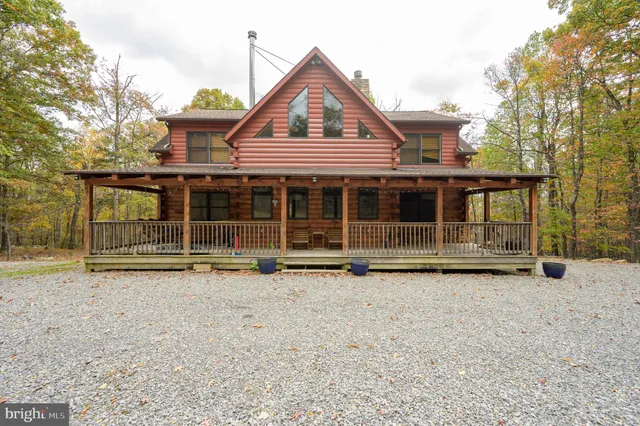 a view of a house with a yard and wooden fence