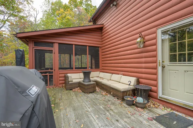 a view of a house with a yard and deck area